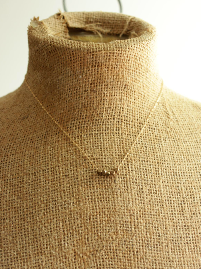brass bead on gold necklace