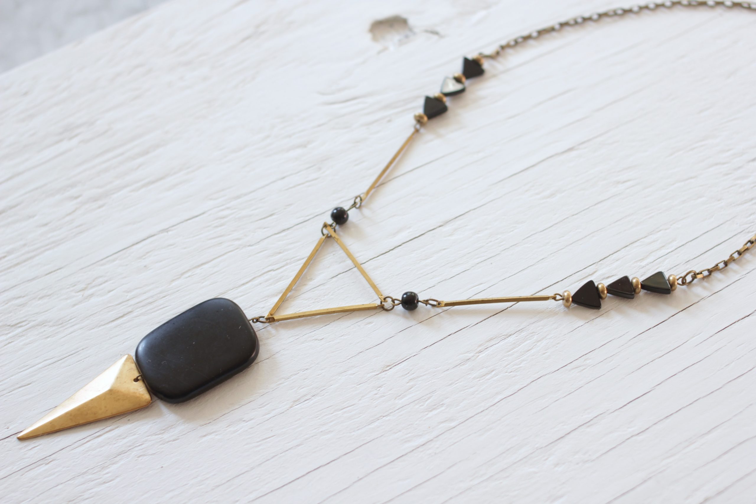 Black geometric necklace made with onyx stones and brass components and chain