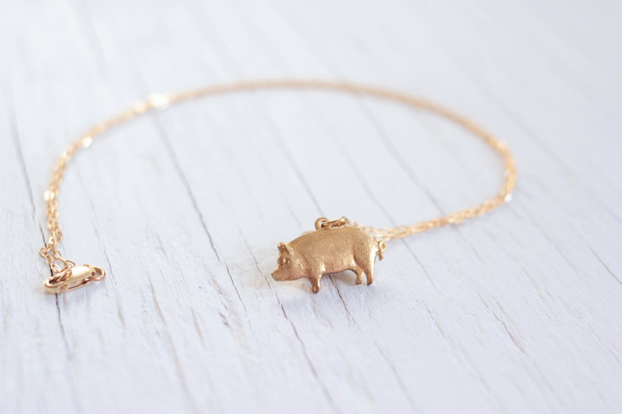 Gold pig pendant necklace